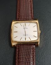 GENTLEMANS OMEGA GENEVE WRISTWATCH with a rectangular gold plated case and champagne dial with baton