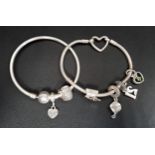 TWO PANDORA CHARM BRACELETS comprising a Moments Heart Closure Snake Chain Bracelet with four