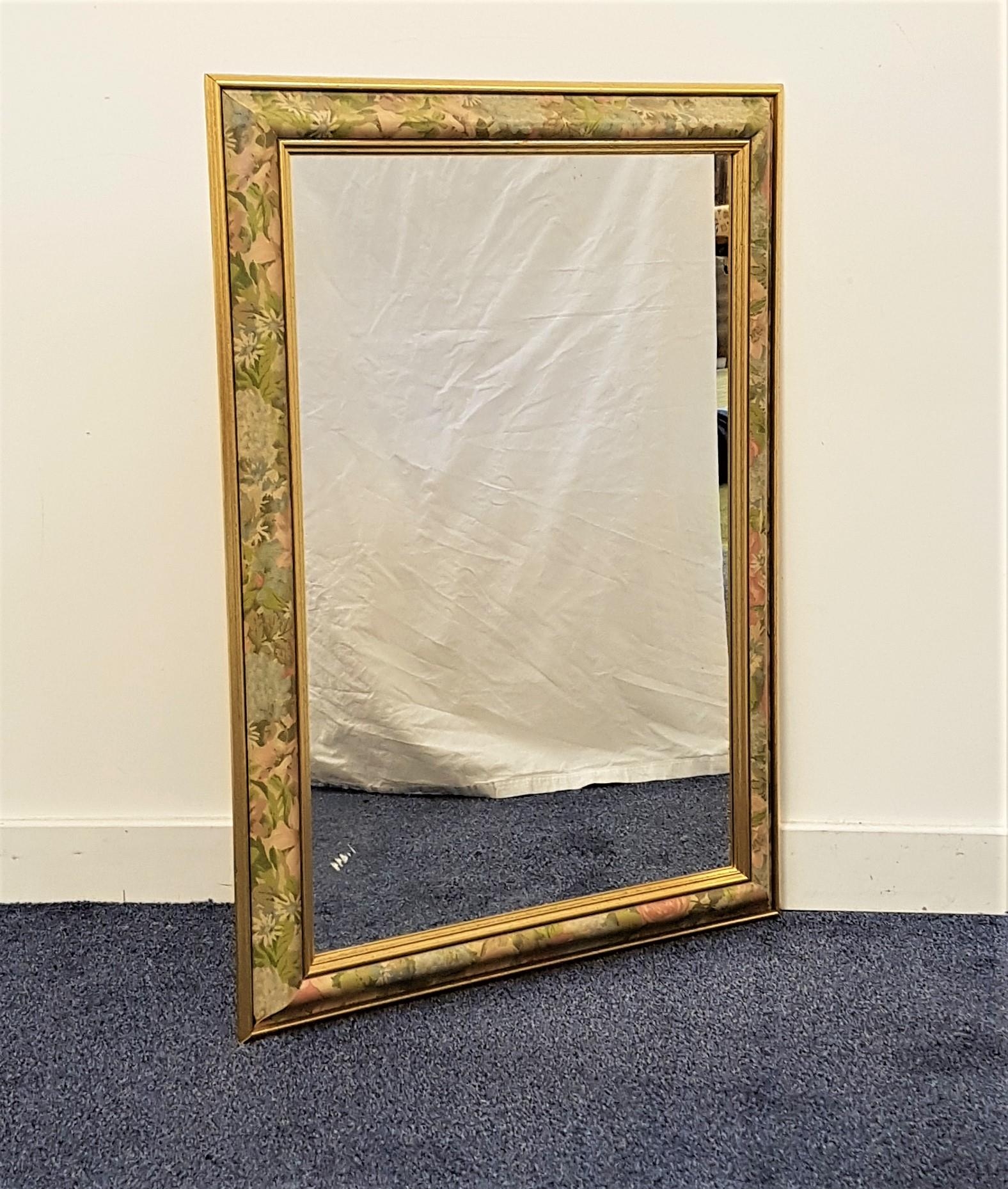 RECTANGULAR WALL MIRROR in a cushion frame decorated with flowers, with a plain plate, 89cm x 63.5cm