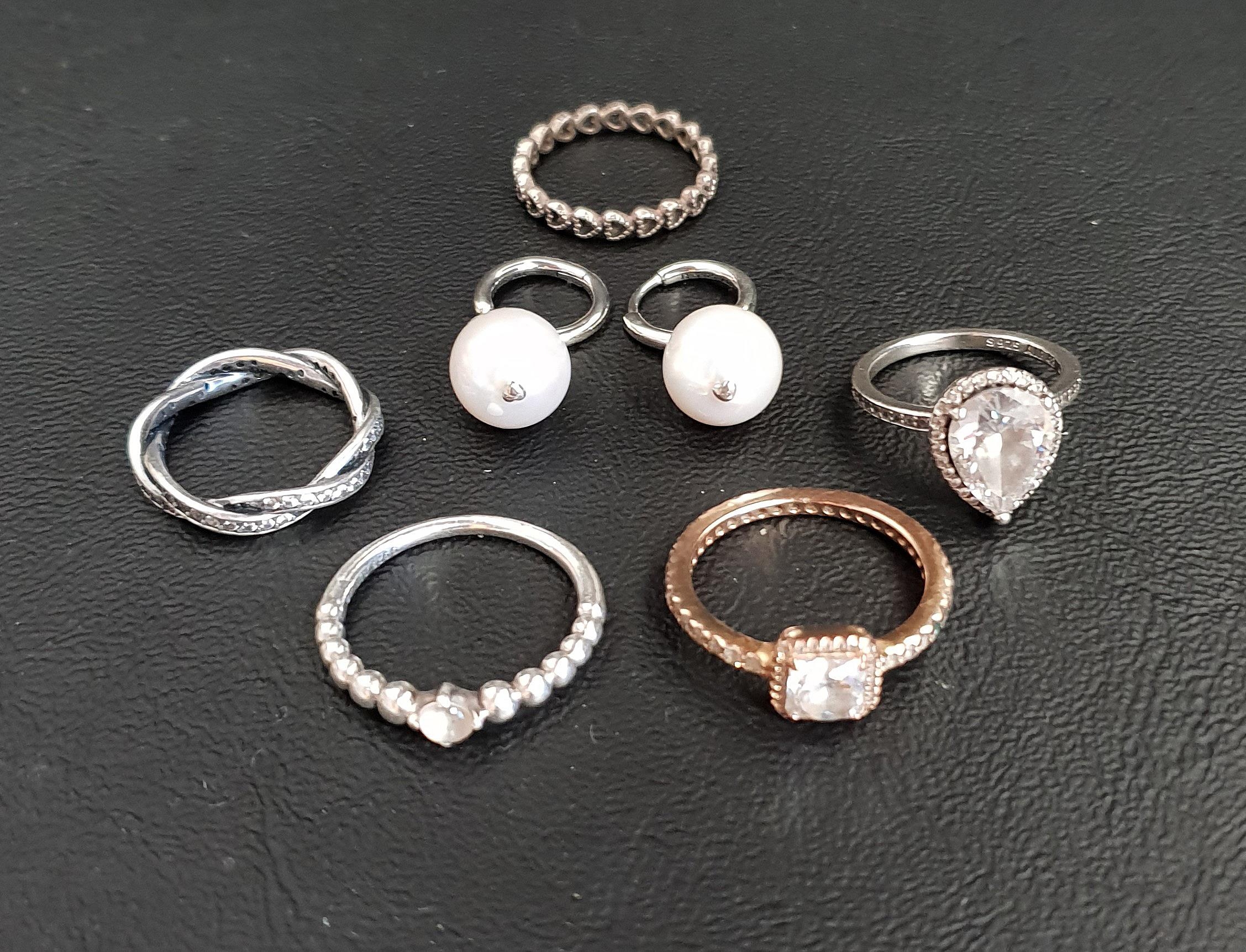 FIVE PANDORA RINGS comprising a Sparkling Teardrop Halo ring, a Sparkling Twisted Lines ring, a Band