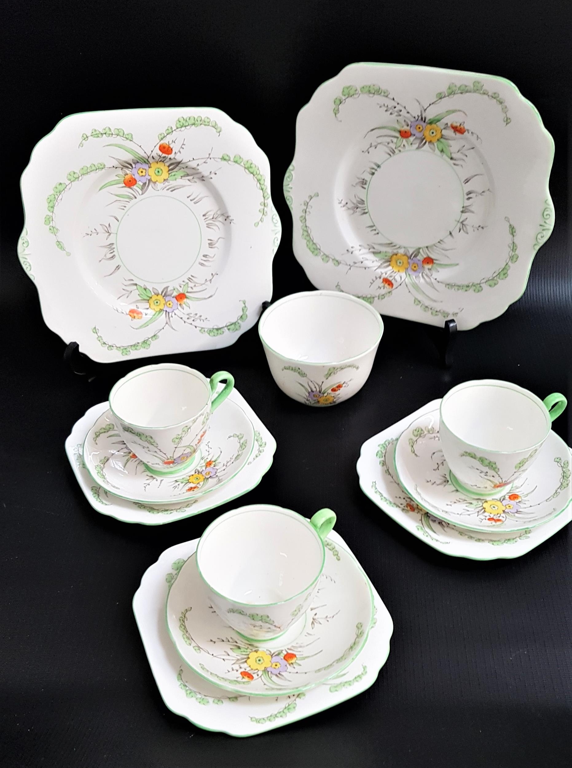 GLADSTONE CHINA PART TEA SET decorated with a white ground with flowers and green highlights,