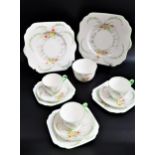 GLADSTONE CHINA PART TEA SET decorated with a white ground with flowers and green highlights,