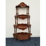 VICTORIAN WALNUT WHATNOT the four shaped and inlaid tiers with shaped raised backs and turned