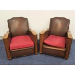 PAIR OF 1920s CLUB ARMCHAIRS with oak shaped arms and a shaped padded back, sides and loose seat