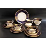 AYNSLEY TEA SET with a navy blue, gilt and cream ground comprising twelve cups and saucers, twelve