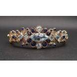 BLUE TOPAZ, SAPPHIRE AND DIAMOND SET BANGLE in silver gilt with pierced detail to the reverse of the