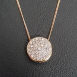 PAVE DIAMOND SET CIRCULAR PENDANT in fourteen carat gold and on eighteen carat gold chain, the