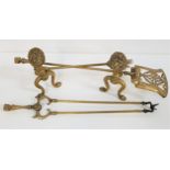 PAIR OF BRASS ANDIRONS with lion masks and shaped supports, together with a brass companion set of a