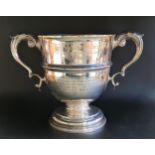 VICTORIAN SILVER TWIN HANDLED CUP with presentation inscription and a circular hardwood stand,