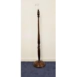 OAK STANDARD LAMP raised on a circular base with a turned and carved column, 159cm high