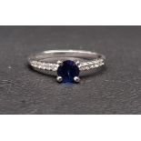 SAPPHIRE AND DIAMOND RING the central round cut sapphire approximately 0.45cts flanked by diamond