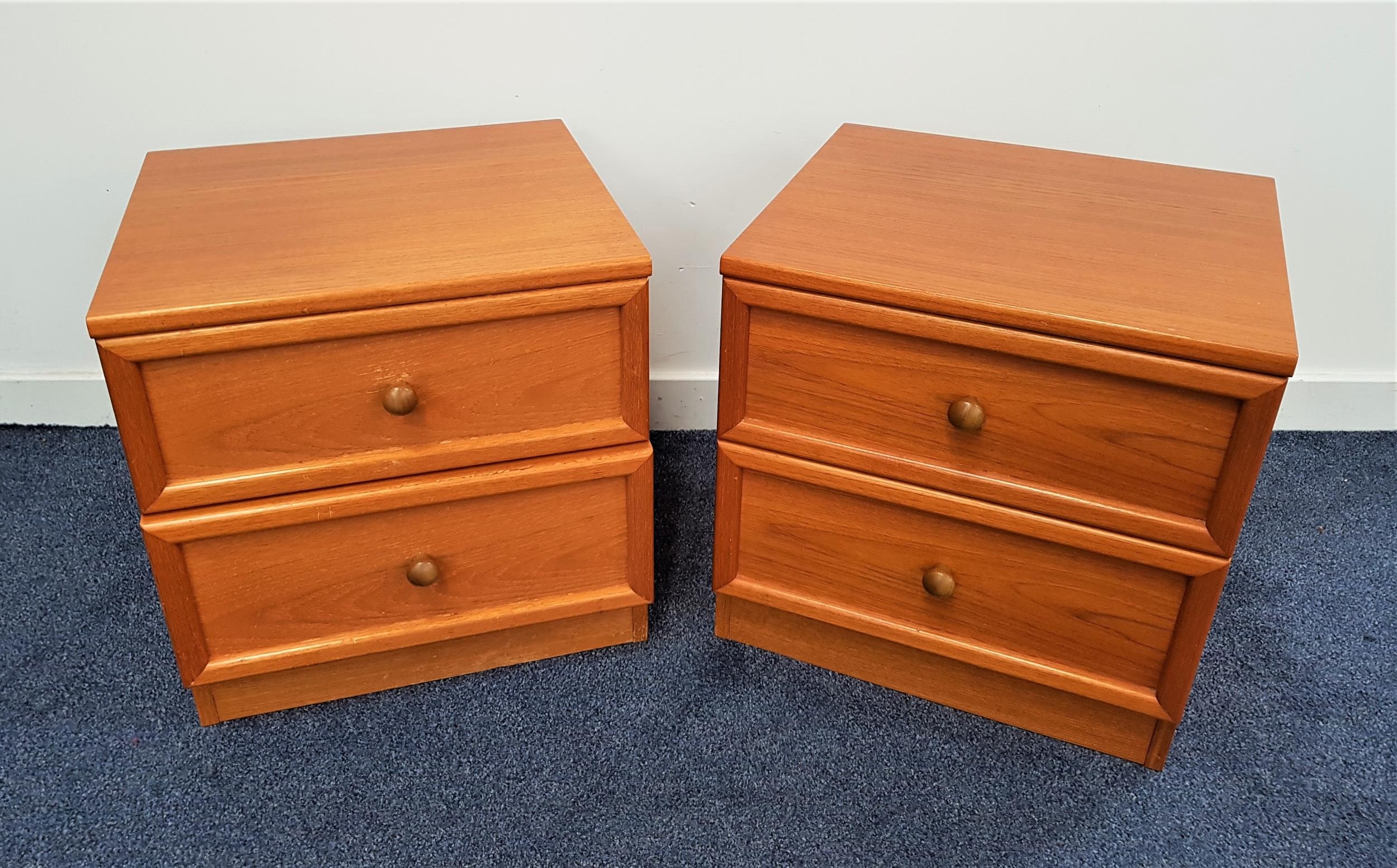 PAIR OF G PLAN TEAK BEDSIDE CHESTS each with a moulded top above two panelled drawers, standing on a