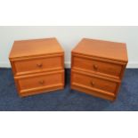 PAIR OF G PLAN TEAK BEDSIDE CHESTS each with a moulded top above two panelled drawers, standing on a