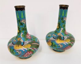 PAIR OF CLOISONNE BOTTLE VASES raised on a circular foot rising to a high waisted cylindrical