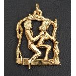 UNUSUAL EROTIC NINE CARAT GOLD PENDANT the male figure with articulated body seated behind the