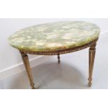 POLISHED GREEN ONYX TOP OCCASIONAL TABLE with a circular top on a gilt brass base with tapering