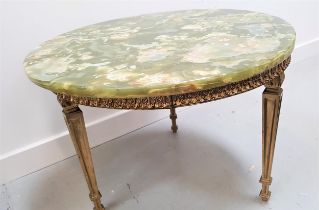 POLISHED GREEN ONYX TOP OCCASIONAL TABLE with a circular top on a gilt brass base with tapering