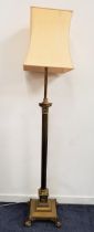 EARLY 20th CENTURY BRASS STANDARD LAMP raised on a square stepped base with lion paw feet, with a