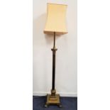 EARLY 20th CENTURY BRASS STANDARD LAMP raised on a square stepped base with lion paw feet, with a