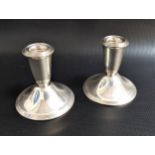 PAIR OF WEIGHTED NEWPORT STERLING SILVER DWARF CANDLESTICKS marked to bases 'Ce'ent filled