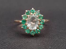 AQUAMARINE AND EMERALD CLUSTER RING the central oval cut aquamarine approximately 1ct in twelve