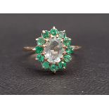 AQUAMARINE AND EMERALD CLUSTER RING the central oval cut aquamarine approximately 1ct in twelve