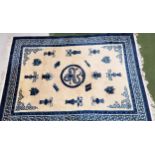 LARGE CHINESE WASH RUG with a cream ground and centred with a dragon and other blue ground motifs,