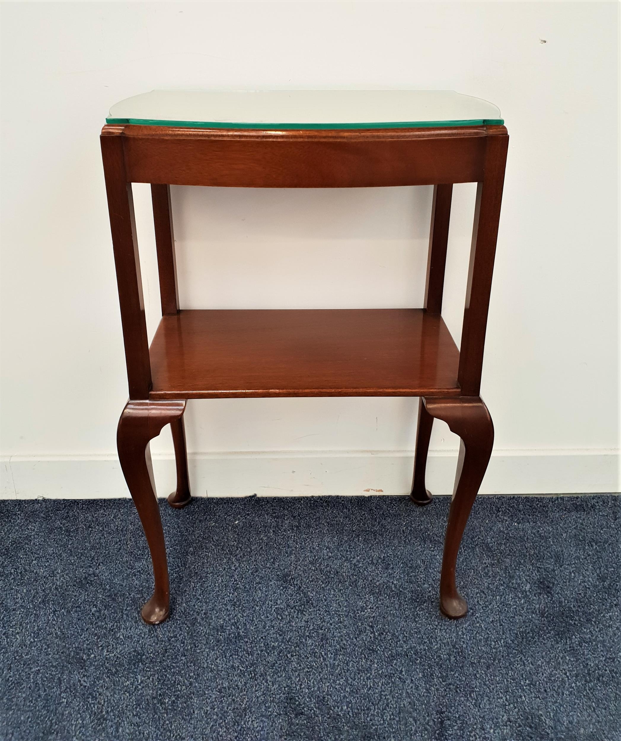 MAHOGANY SIDE TABLE the shaped moulded bow front top with a shelf below, standing on cabriole