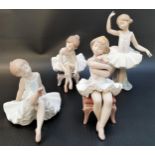 FOUR LLADRO BALLERINA FIGURINES in various repose, all warring tutus, including two seated on