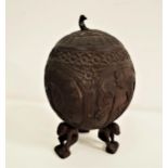 CARVED COCONUT CUP AND COVER with a peacock finial, the body decorated with a peacock and figures,