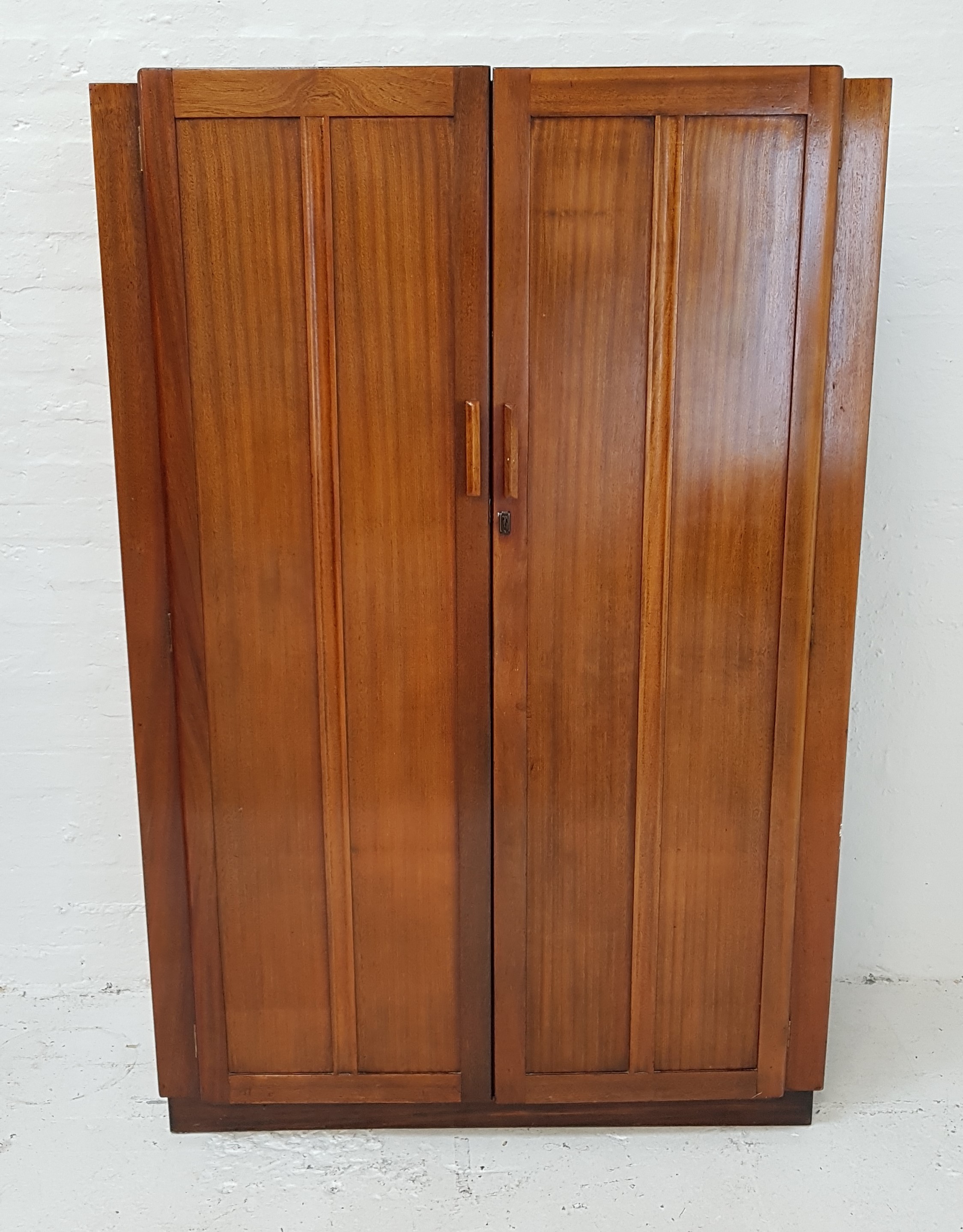 1930s TEAK WARDROBE with a pair of panelled doors opening to reveal an internal mirror and hanging