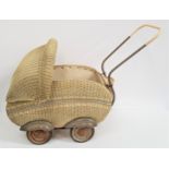 VINTAGE WICKER DOLLS PRAM with a canopy, storage compartment on four wheels