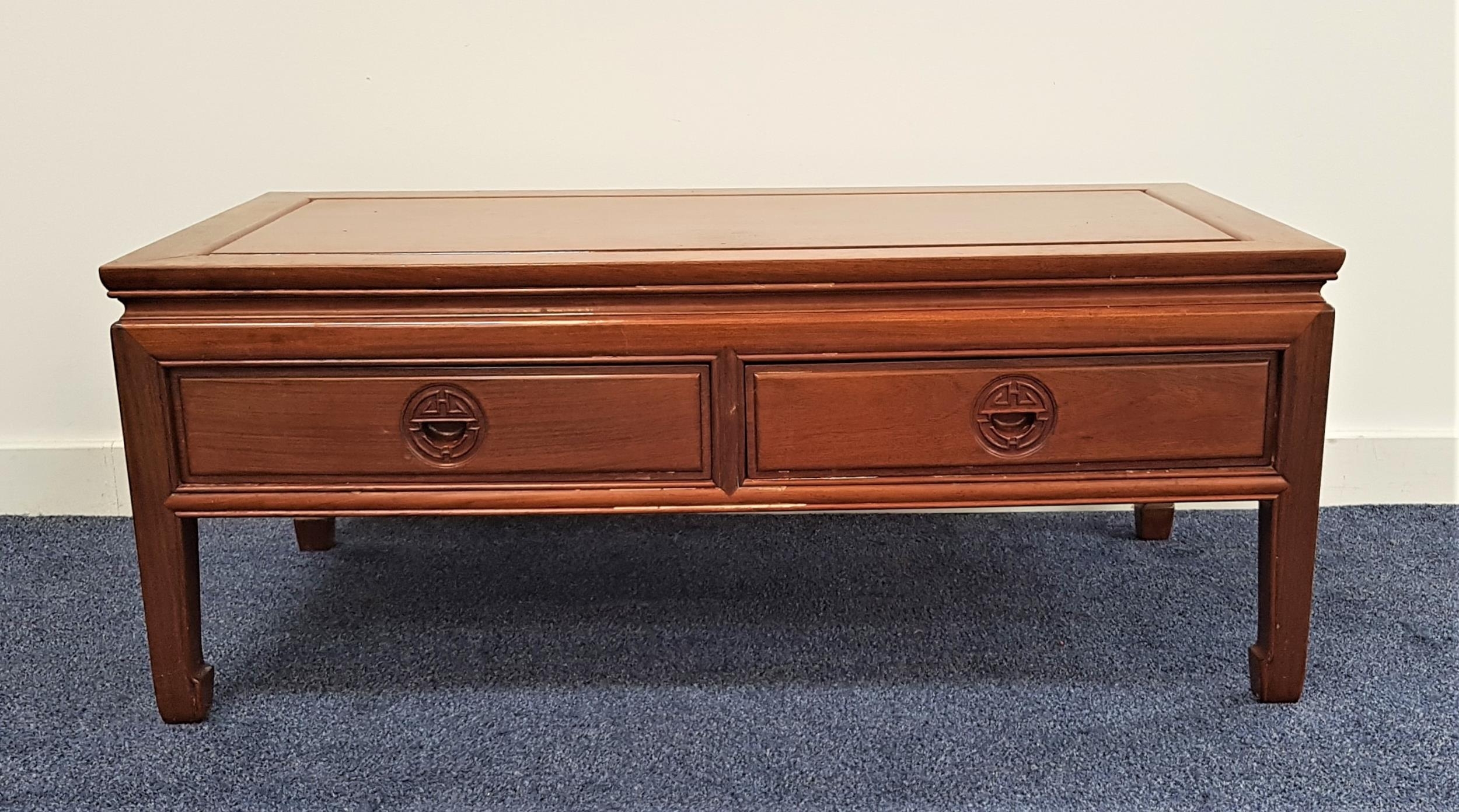 CHINESE TEAK LOW OCCASIONAL TABLE with a rectangular top above two panelled frieze drawers, standing