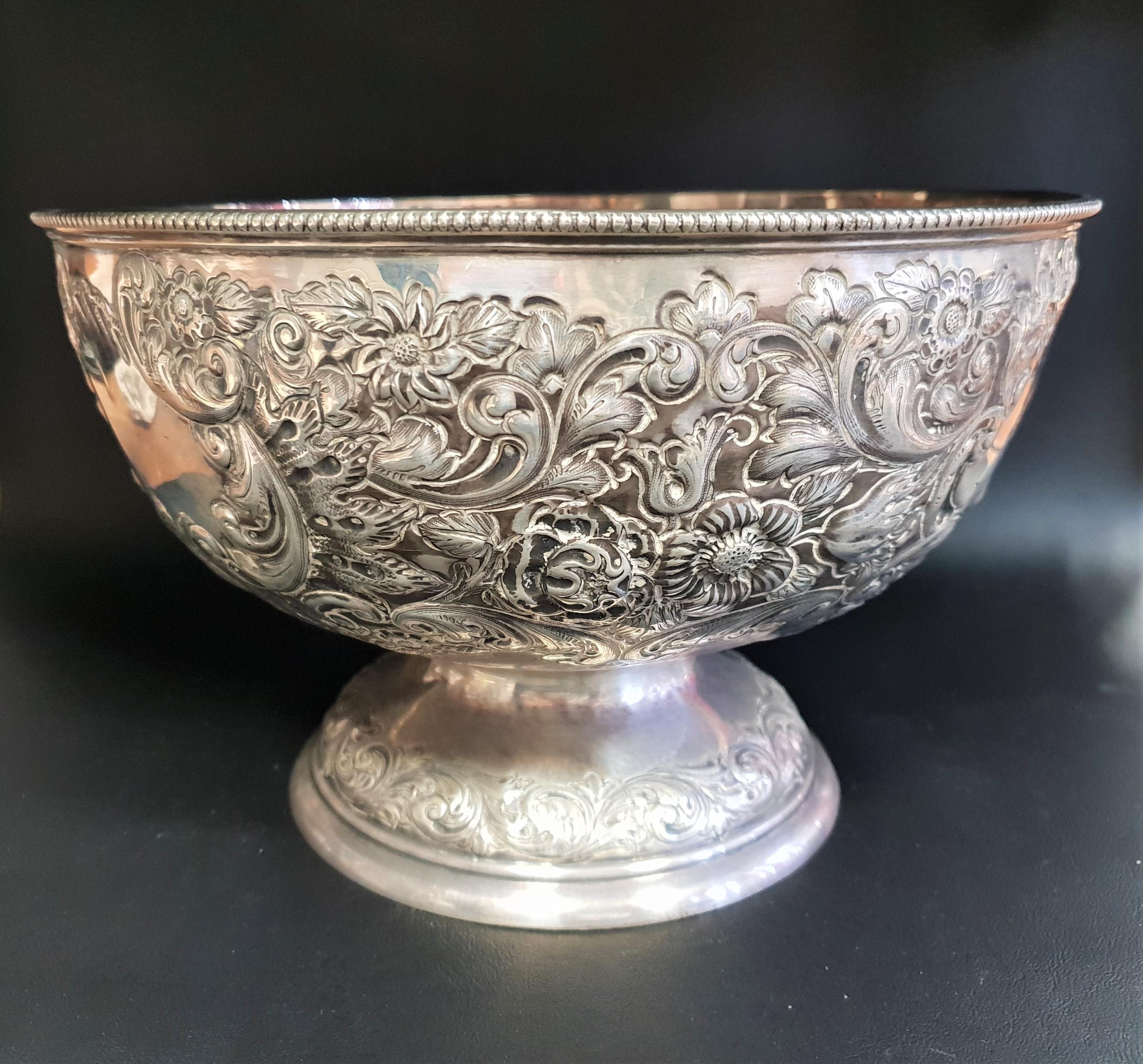 VICTORIAN SILVER ROSE BOWL with elobrate embossed decoration, raised on a circular foot, monogrammed