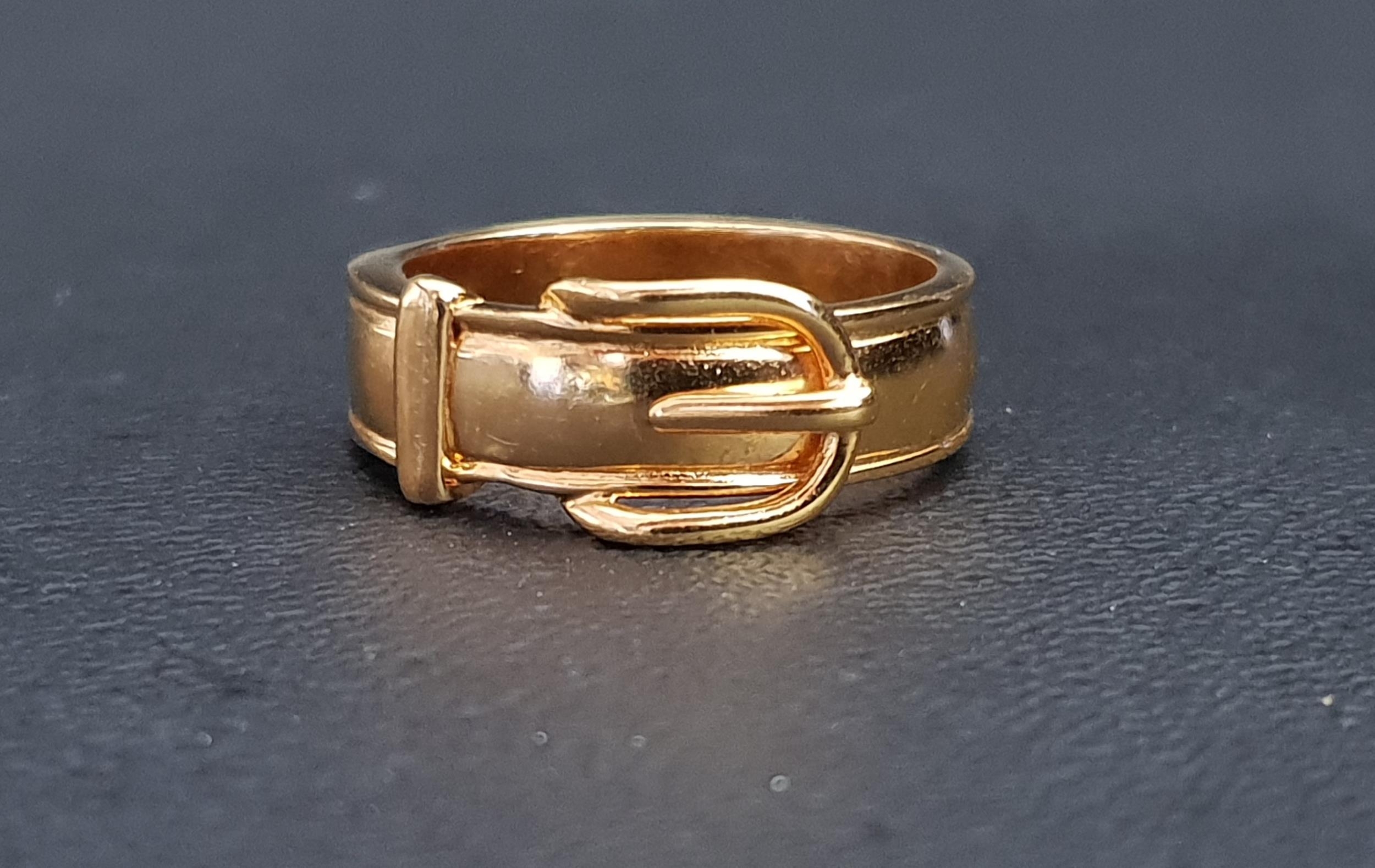 HERMES GILT METAL BUCKLE DESIGN RING the polished band with a buckle motif to the upper section,