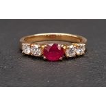 RUBY AND DIAMOND FIVE STONE RING the central oval cut treated ruby approximately 0.75cts, flanked by