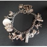 SILVER CHARM BRACELET with mostly silver charms including a galleon, a bull, an elephant, and a