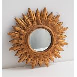 CARVED GILTWOOD STARBURST WALL MIRROR with a circular convex mirror, 49.5cm diameter