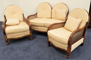 WALNUT AND FIGURED WALNUT THREE PIECE SUITE comprising a two seat sofa with a double arched and