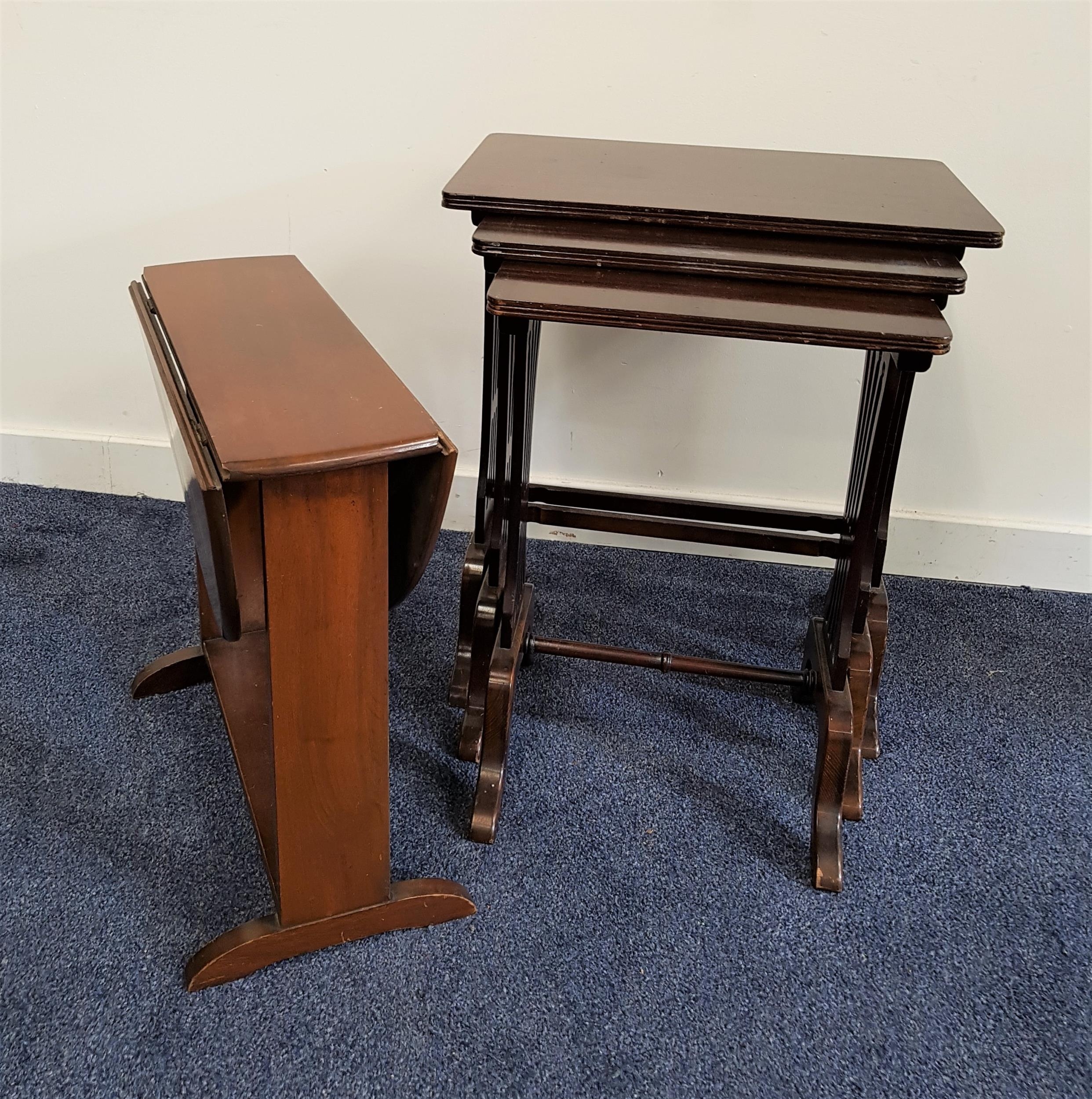 MAHOGANY NEST OF TABLES with rectangular tops and standing on lyre end supports, 60cm high, together