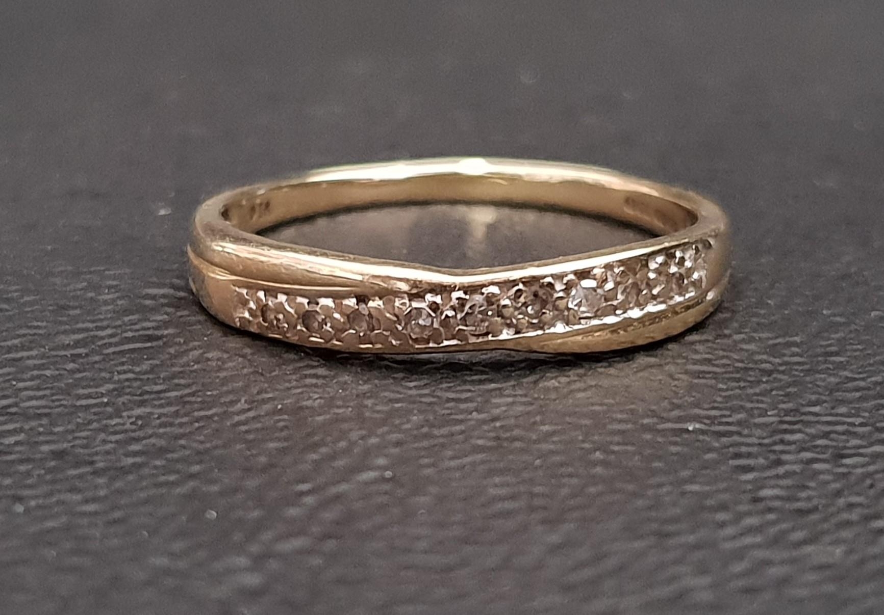 DIAMOND SET RING of crossover design in nine carat gold, ring size Q and approximately 1.5 grams