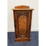 EDWARDIAN WALNUT BEDSIDE POT CUPBOARD with a shaped arched raised back above a plain top with a