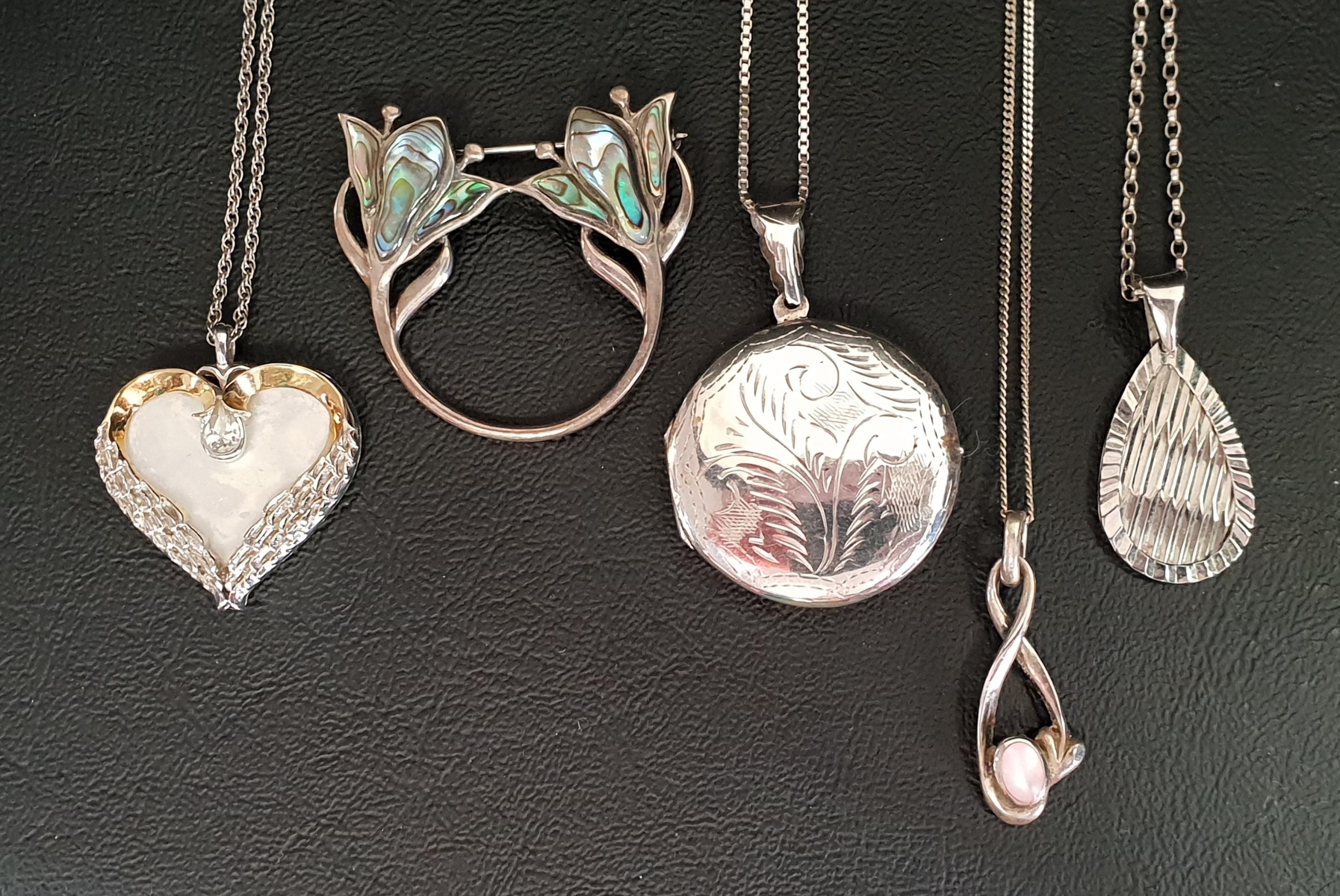 SELECTION OF SILVER JEWELLERY including circular silver locket pendant, three further silver