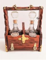 20th CENTURY PINE AND BRASS MOUNTED TANTALUS with two decanters and stoppers with a gin and whisky
