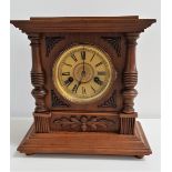 GERMAN WALNUT MANTLE CLOCK the circular dial with Roman numerals, the rear door with a paper