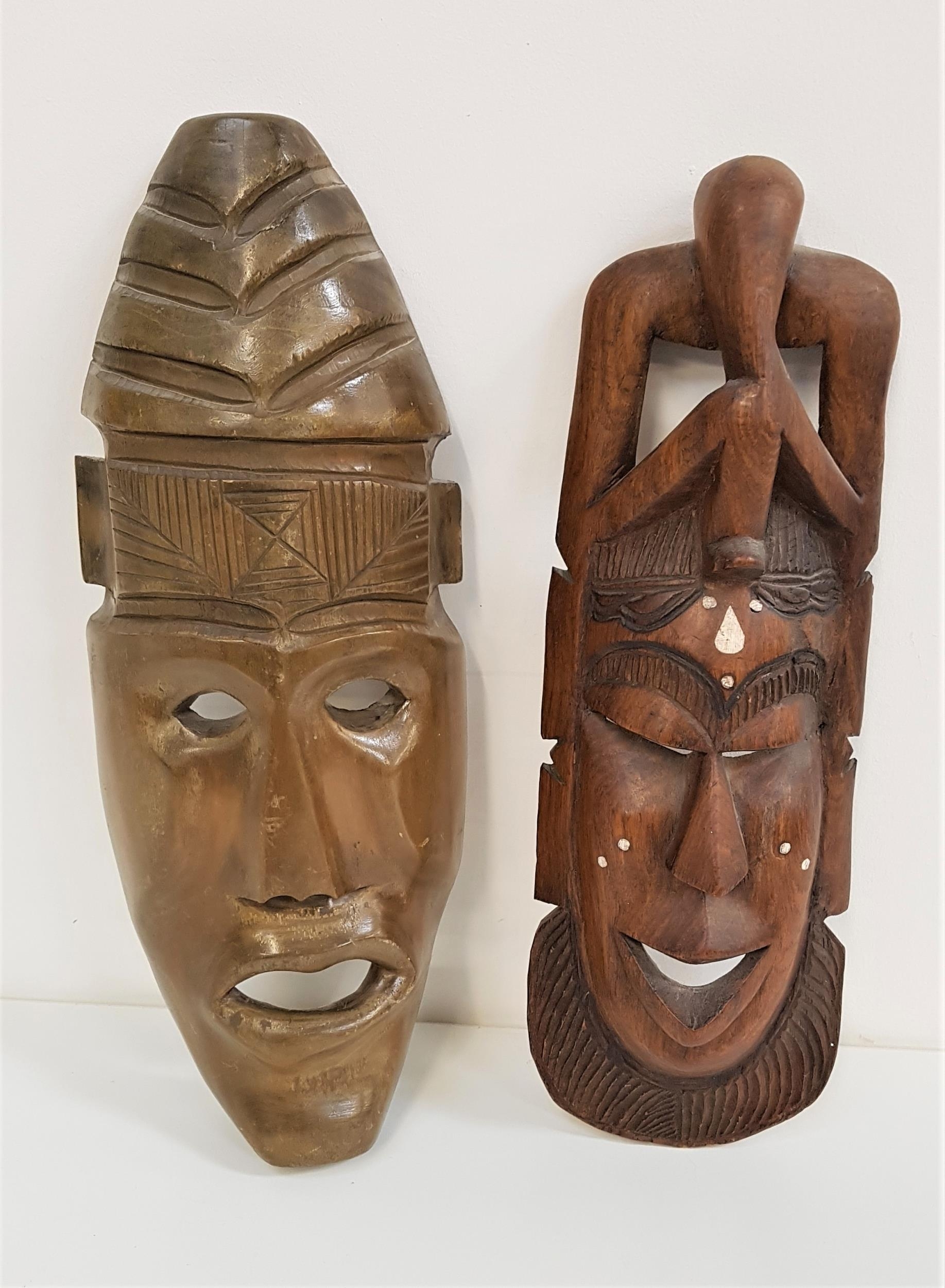 CARVED AFRICAN WALL MASK in teak with pierced detail and inset bone decoration, 44.5cm high,