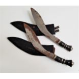 TWO KUKRI KNIVES each with a curved etched blade, 29.5cm long, with an ebony handle and lion mask