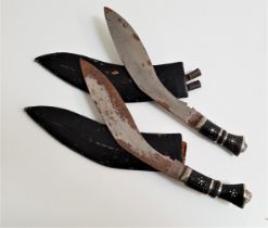 TWO KUKRI KNIVES each with a curved etched blade, 29.5cm long, with an ebony handle and lion mask