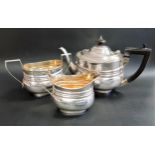 VICTORIAN SILVER BACHELOR TEA SERVICE comprising a tea pot, milk jug and twin handled sugar bowl,