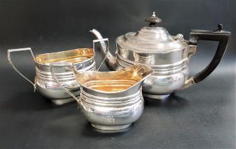 VICTORIAN SILVER BACHELOR TEA SERVICE comprising a tea pot, milk jug and twin handled sugar bowl,
